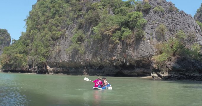 PHUKET, THAILAND, MARCH 2017:  Padling in small boats, through caves and alleys in Phi Phi Islands