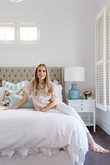 Stylish young woman in a hamptons styled bedroom