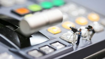 Miniature people : cameraman ,Videographer at work shooting on switcher control of Television...