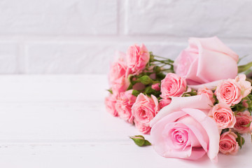 Tender pink roses flowers  on  white wooden background.