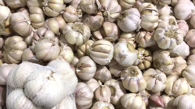Fresh organic healthy garlic in the food market. Garlic vegetable. Close up 4K footage.