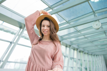 Portrait of young woman an airport lounge waiting for boarding in international airport