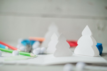 Christmas table with various items. Woman's hands putting a letter in an envelope