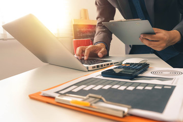  businessman hand working with laptop computer in modern office with virtual icon diagram at modernoffice in morning light 
