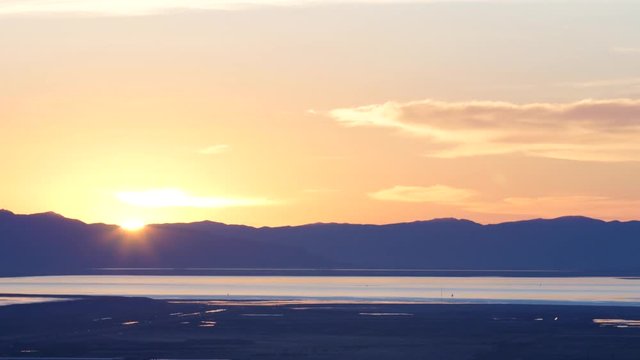 The Great Salt Lake shines at sunset in Salt Lake City, UT.