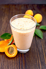 Milkshake apricot in high glassful on board