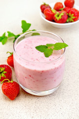 Milkshake strawberry with berries on granite table