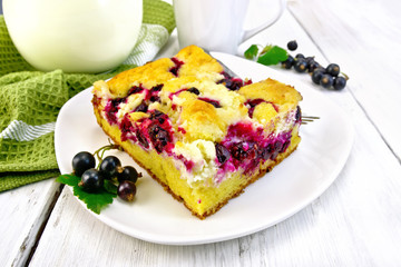 Pie with black currant in plate on light board