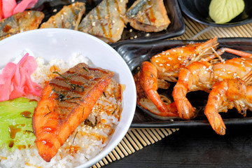 Japanese cuisine - Grilled salmon steak with rice, grilled saba fish with teriyaki sauce and grilled shrimps