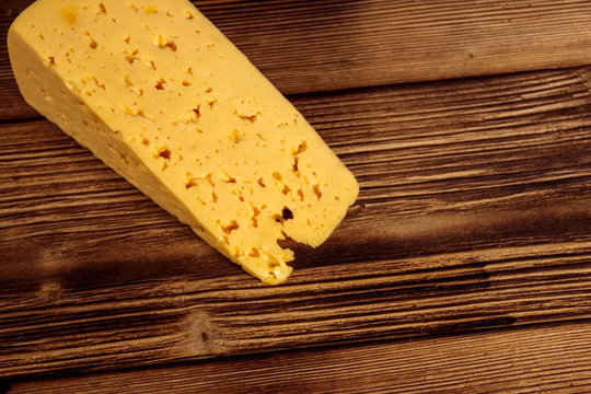 Piece of cheese on wooden table
