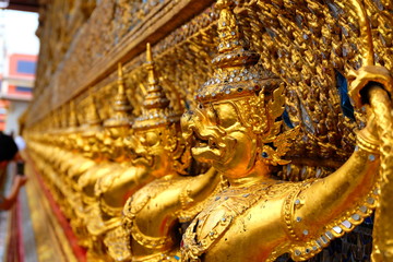 Garuda in (Wat Phra Kaew ) Temple of the Emerald Buddha  Bangkok Thailand - A line of golden demons at the Grand Palace in Bangkok, Thailand