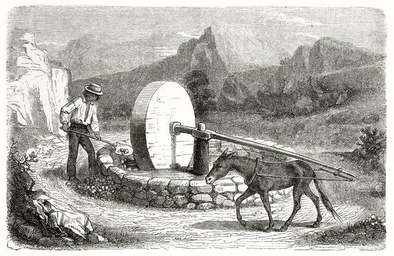 Old illustration of gold prospector in California working in a crushing mill. Created by Chassevent after previous engraving by unknown author, published on Le Tour du Monde, Paris, 1862