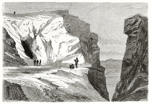 Old rough illustration of Pentelic marble caves in Mount Pentelicus Greece. Black cave entrance and cleft over the view to the horizon. Created by Proust published on Le Tour du Monde Paris 1862