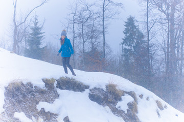 Woman walk and rest in snowy mountains forest, alpine view, snow on hills. Winter magical time for good vacation.  