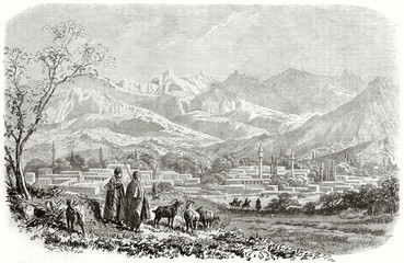 Ancient large view view of Tarsus and Taurus mountains in background Cilicia (in our day Turkey), oriental style city and shepherds directed to it. By Grandsire published on Le Tour du Monde 1862