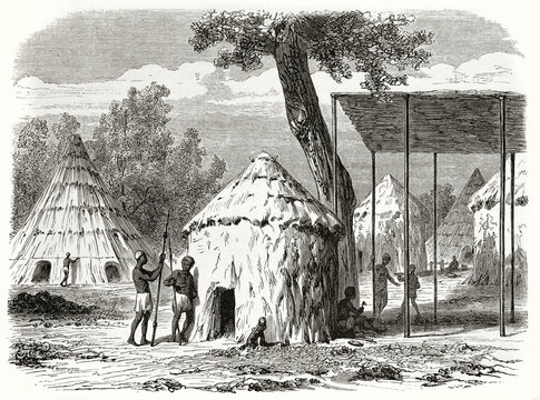 Ancient african tribe in his village made by straw and mud huts, Sudan. Created by Girardet and Levy after Bolognesi published on Le Tour du Monde Paris 1862