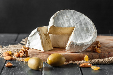 Cheese on the wooden table - obrazy, fototapety, plakaty