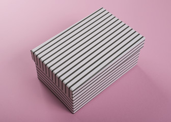 White  box with black stripes on pink  background. Mockup.