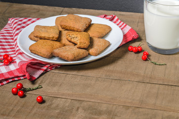 Biscuits, milk, red napkin, Christmas decor with free space for text.