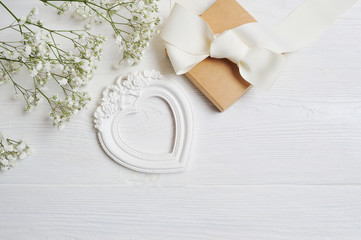 Mock up Composition of white flowers rustic style, hearts love and a gift for St. Valentine's Day with a place for your text. Flat lay, top view photo mock up