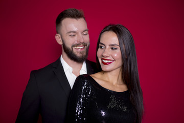 I love you. Beautiful couple in black luxury dress on a red background. Valentine's Day. Women's Day. March 8