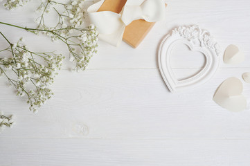 Mock up Composition of white flowers rustic style, hearts love and a gift for St. Valentine's Day with a place for your text. Flat lay, top view photo mock up