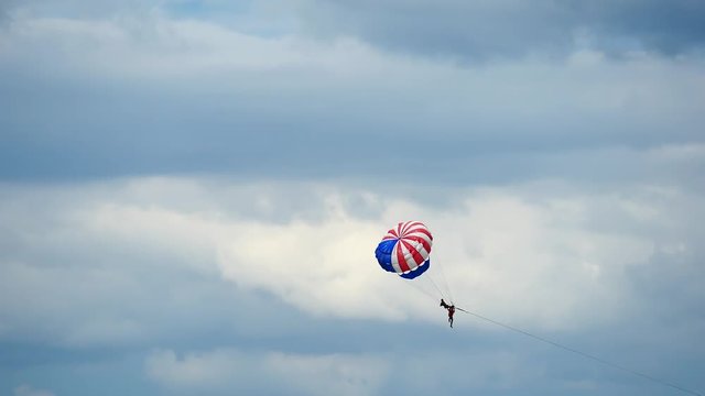 Closr up of parachuting or parasailing with blue sky background.