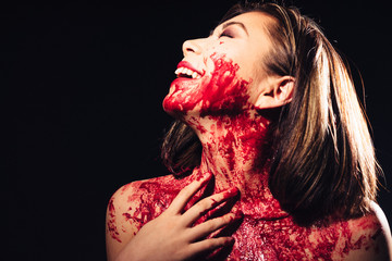 girl in blood makeup on sark background