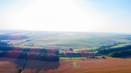 Top view of the farmhouses with gardens and the road