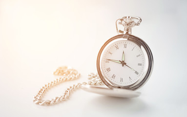 old vintage watch on a chain on a white background