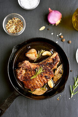 Roasted pork steak in frying pan