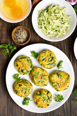 Diet vegetable cutlet from carrot, zucchini, potato on wooden table