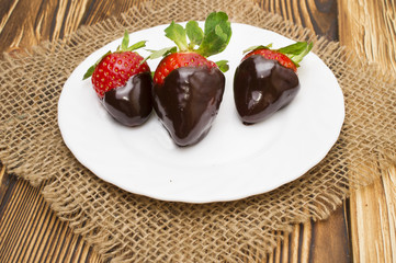 strawberry in chocolate over white background