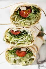 Fresh tortilla wraps with vegetables and chicken. Gourmet conception.