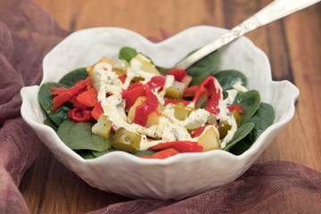 warm salad with potato , salted cucumber and red pepper