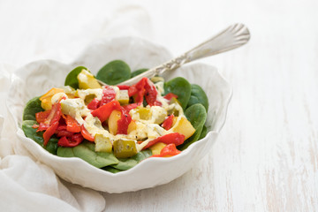 warm salad with potato , salted cucumber and red pepper