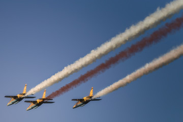 Reactive jet plane flying in formation on blue sky