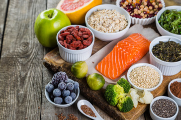 Selection of superfoods on rustic background