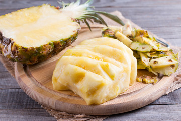 Cutting fresh pineapple on a cutting board