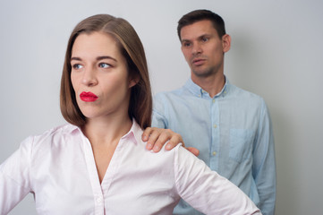 Husband apologizes to his wife. Blurred man asking forgiveness to attractive woman in casual clothes on white background