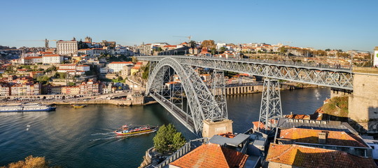 Large panoramic view on Dom Luis I bridge on Douro River at sunset time. Porto. Portugal