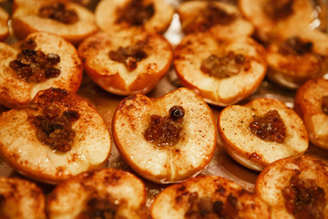 baked halves of apples with honey, cinnamon and raisins