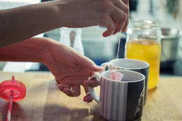 Fototapeta na wymiar Close up of woman making tea.