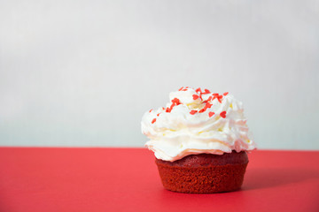 Red velvet cupcake on red background, muffin. Copy space. Valentine's card.