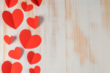 Red paper hearts on wooden background. Valentines day.