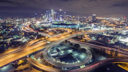 Aerial view freeway interchange downtown Los Angeles skyline night 4K timelapse