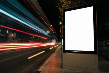 Blank white advertisement lightbox at night. Mock-up design concept. Car lights.