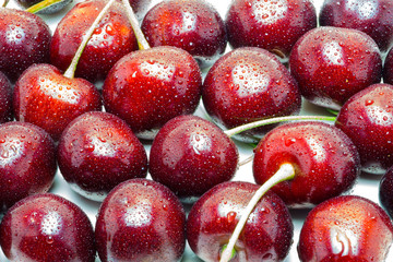 Wet ripe fresh cherries isolated on white background.