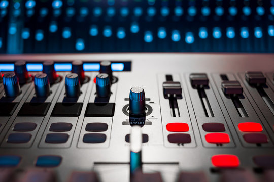 digital audio mixer in recording, editing, broadcasting studio. shallow dept of field. music background