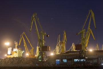 Port terminal of bulk cargo at night time. Industrial port at night